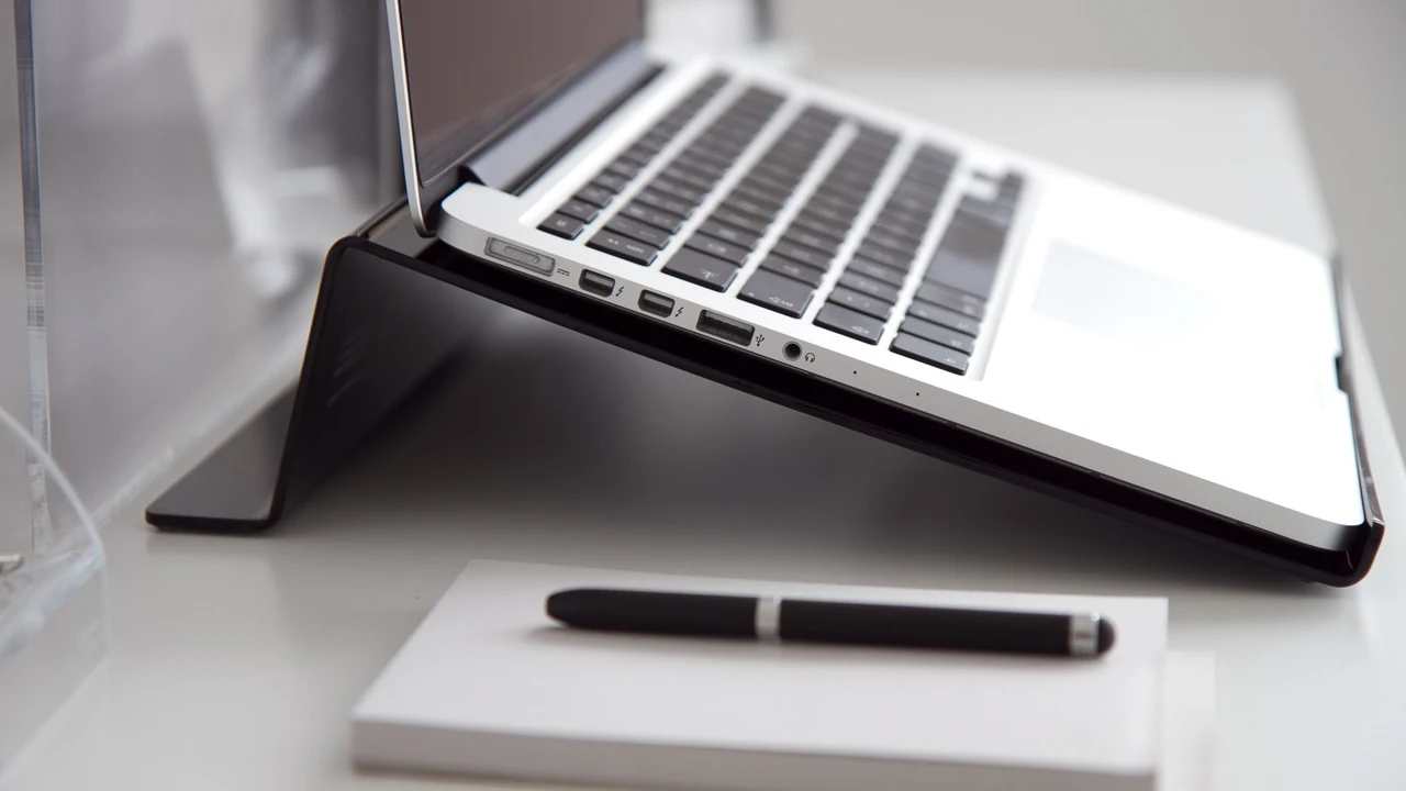 Laptop, notebook and pen on a desk