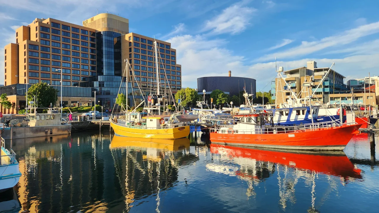 Fishing boats moored along Hobart’s waterfront beside historic harbour buildings